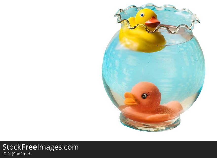 Two rubber duckies swimming in a blue vase