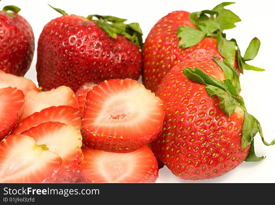 Strawberries, whole and sliced, isolated on white. Strawberries, whole and sliced, isolated on white