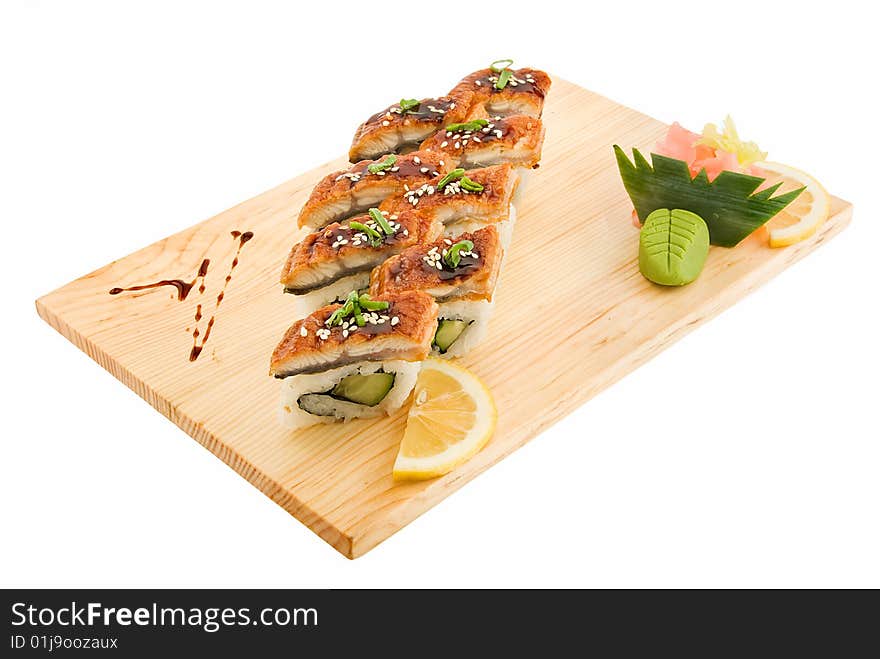 Appetizing aromatic rolls on wooden plate isolated. Appetizing aromatic rolls on wooden plate isolated