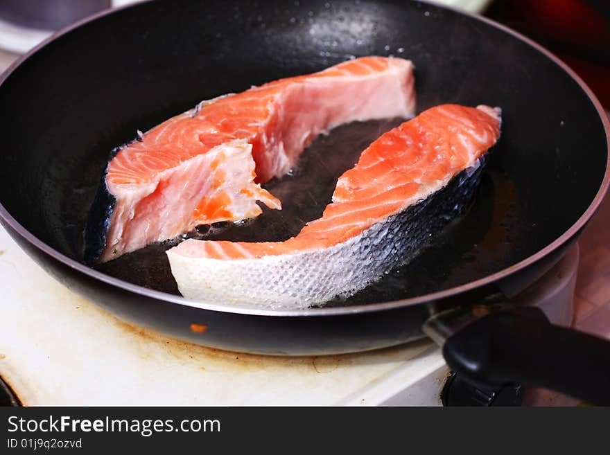 Fresh slice of salmon in the frying pan