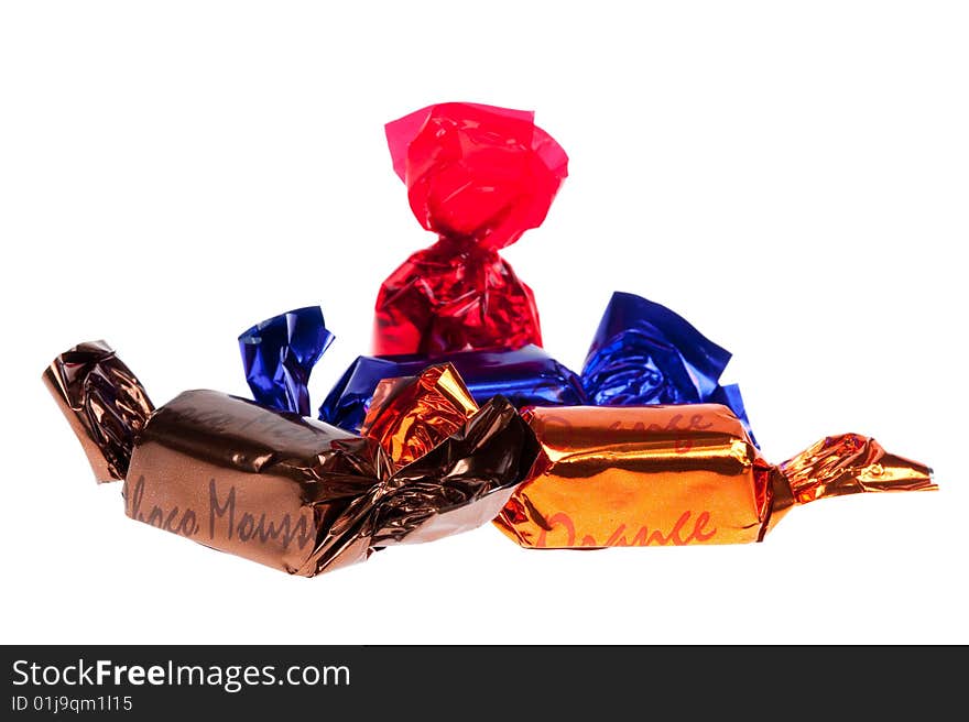 Chocolate praline in foil isolated on white background