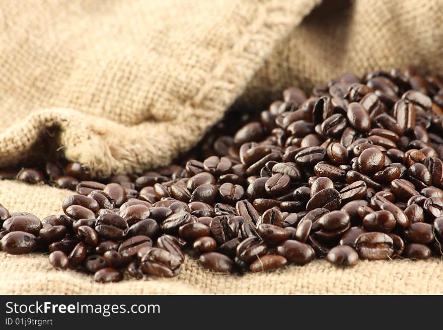 Coffee beans rolled out of a canvas bag. Coffee beans rolled out of a canvas bag