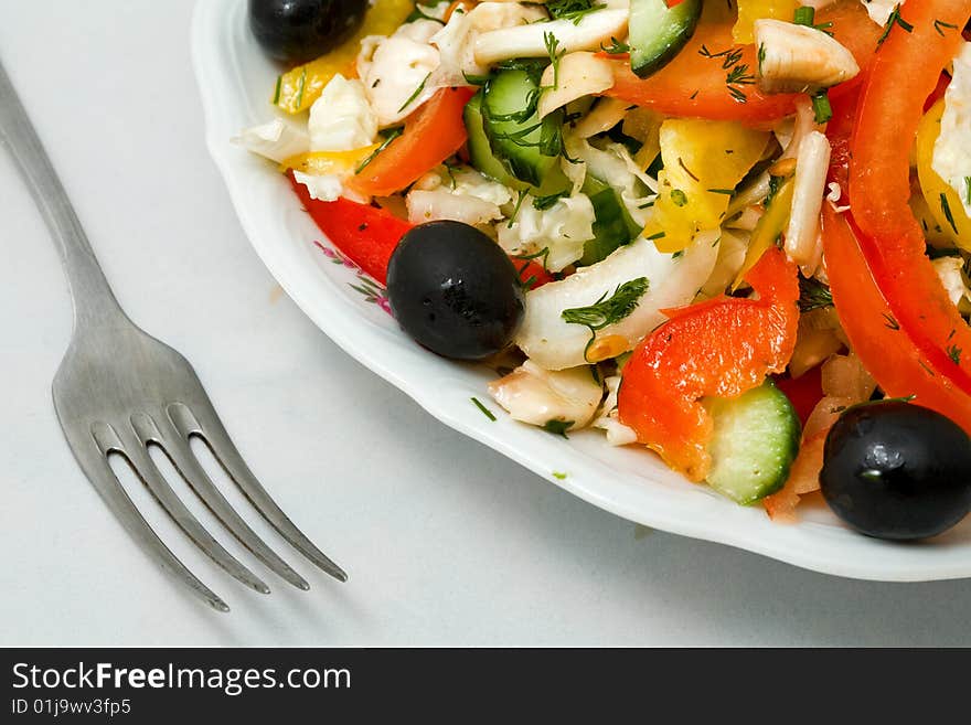 Stock photo: an image of fork and fresh salad on the plate. Stock photo: an image of fork and fresh salad on the plate