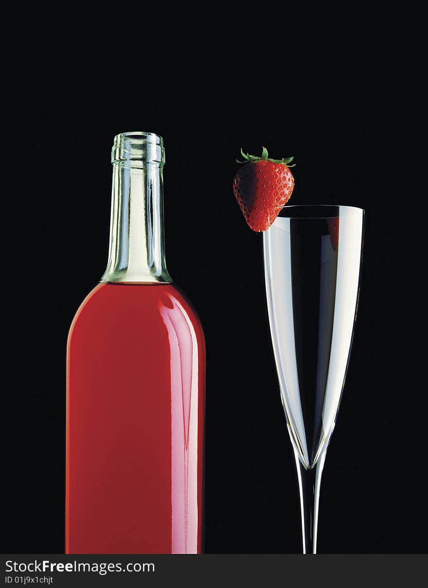 Wine bottle with a strawberry on a glass. Wine bottle with a strawberry on a glass