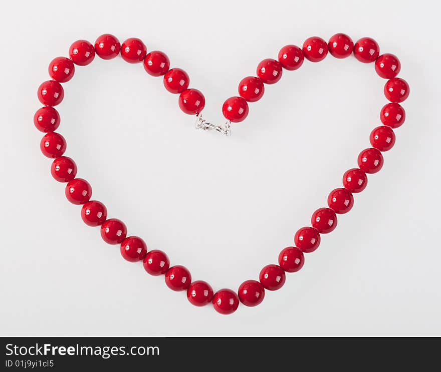 Red mardi gras beads in the form of heart. Red mardi gras beads in the form of heart