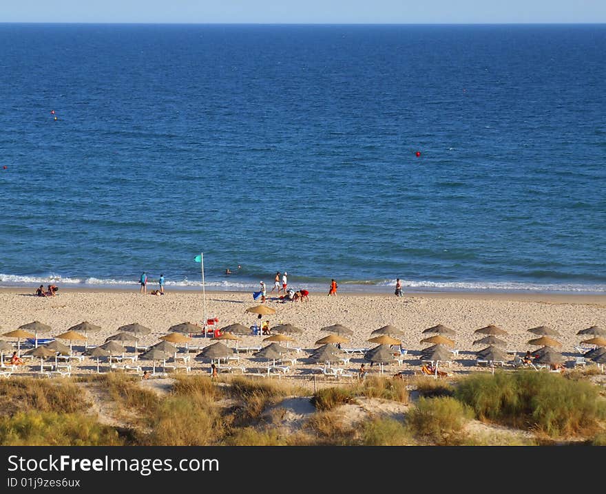 Nice beach, with blue sea and straw sunshades. Nice beach, with blue sea and straw sunshades