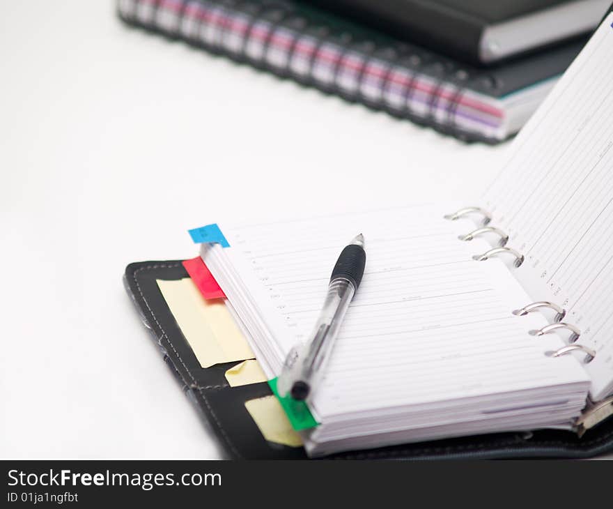 Office stationary - Pen and diary on white background