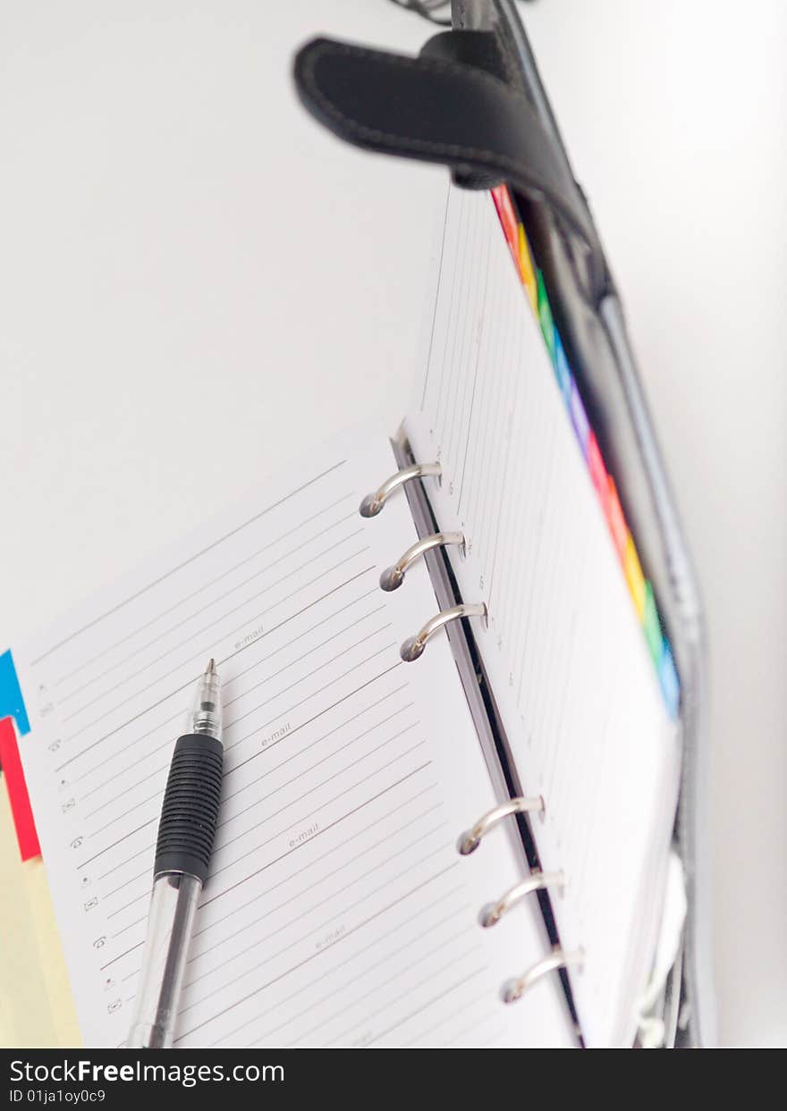 Office stationary - Pen and diary on white background