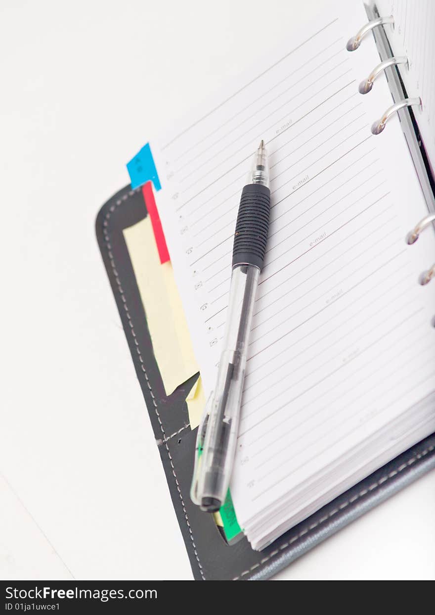 Office stationary - Pen and diary on white background