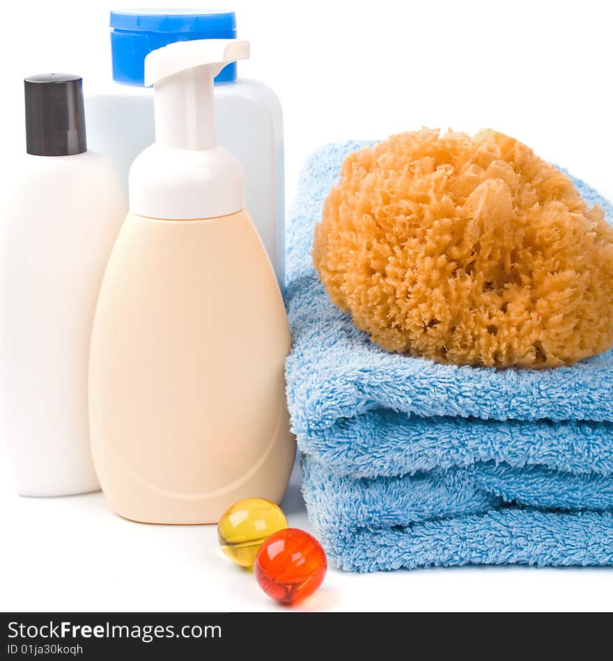 Body care products and towel on white background