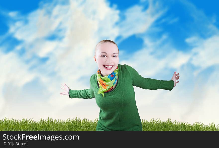 Happy smiling female wearing green cardigan against the blue sky and spring meadow. Happy smiling female wearing green cardigan against the blue sky and spring meadow