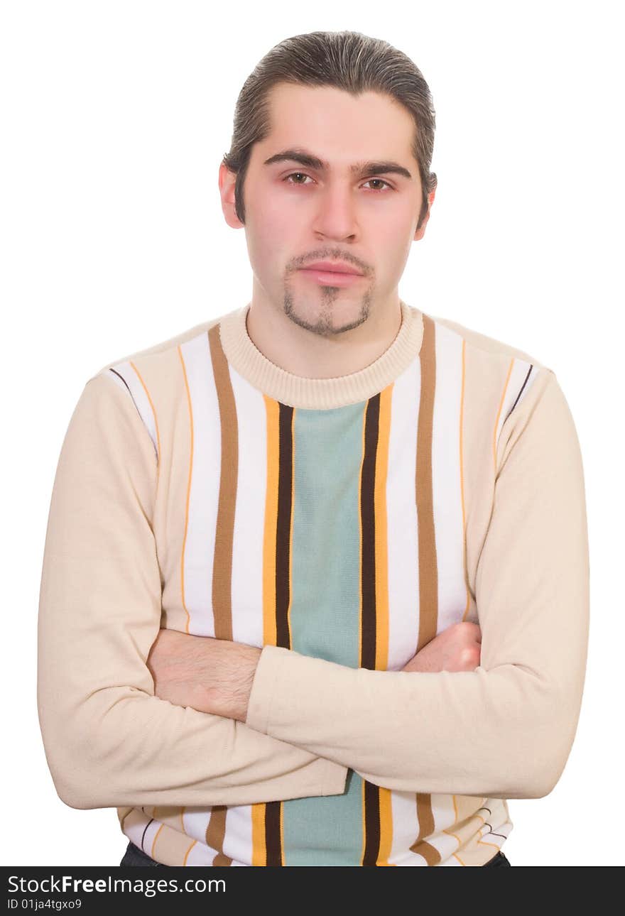 Serious dark haired caucasian man with hands folded on chest in striped sweater isolated. Serious dark haired caucasian man with hands folded on chest in striped sweater isolated