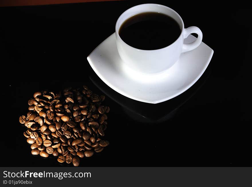 Coffee cup with highlited coffee beans