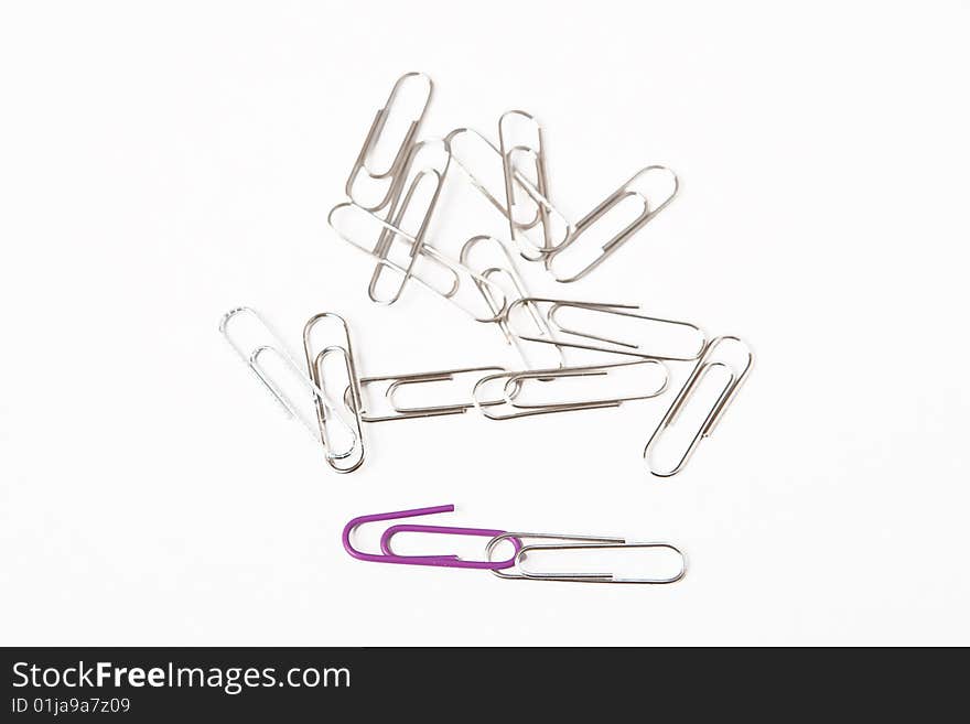 Paperclips on white office desk.