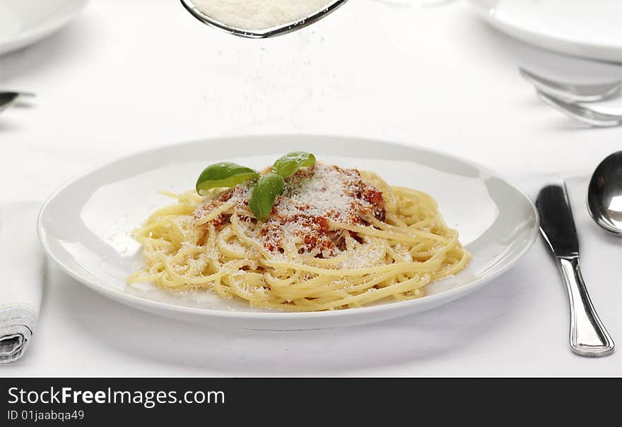 Pasta with tomato sauce basil and grated parmesan