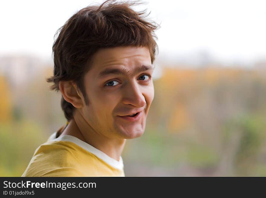 The confused young man in a yellow T-shirt. The confused young man in a yellow T-shirt.