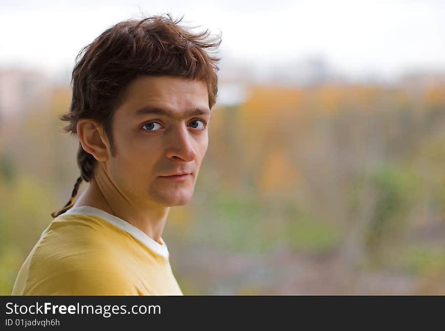 The surprised young man in a yellow T-shirt.