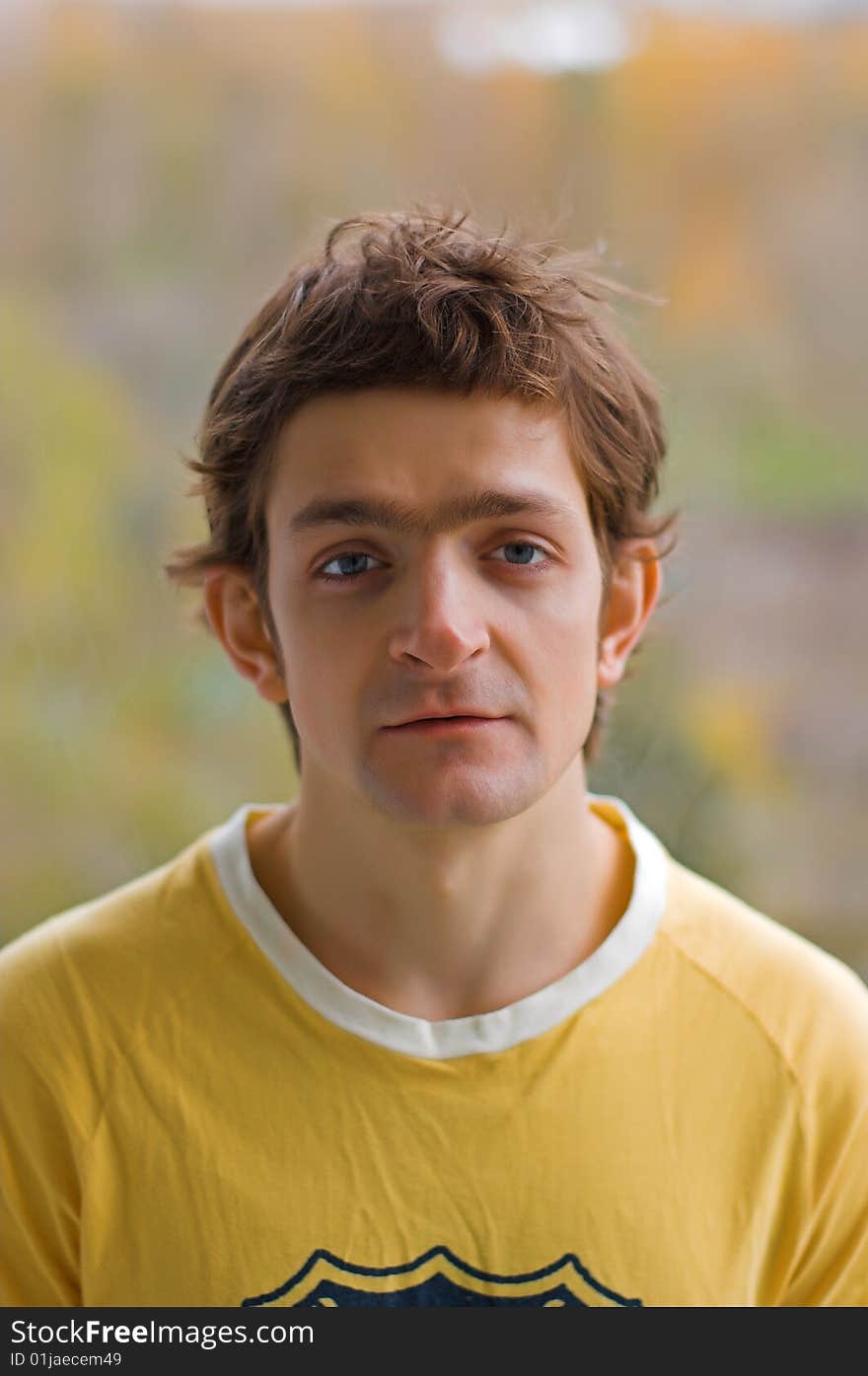 A fleer of the young man in a yellow T-shirt. A fleer of the young man in a yellow T-shirt.