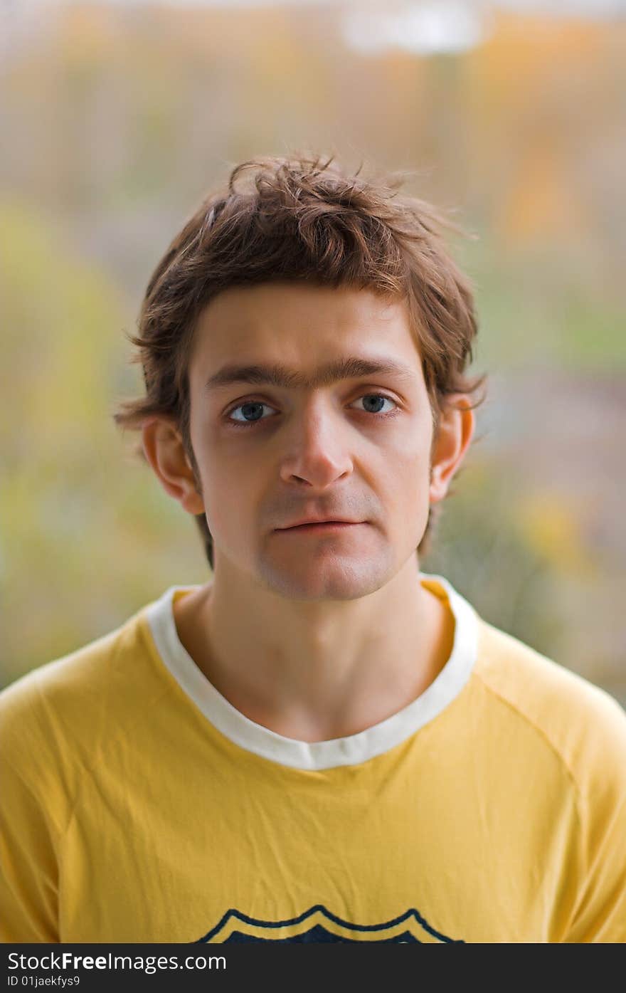 The upset young man in a yellow T-shirt. The upset young man in a yellow T-shirt.