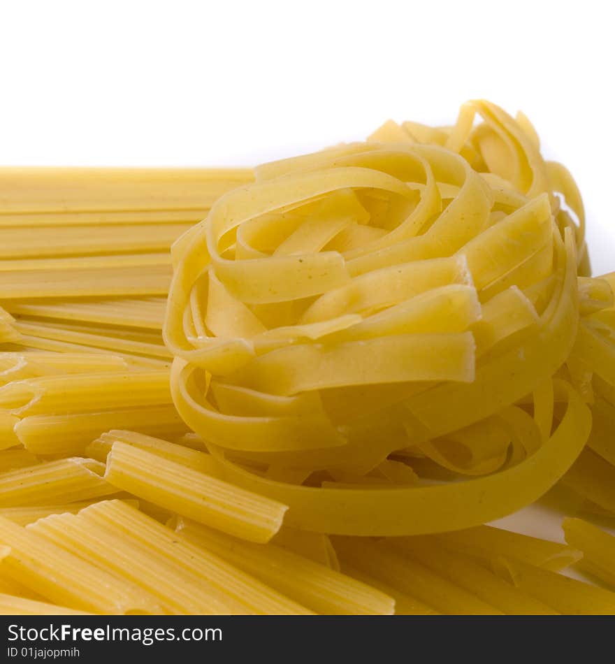 Various shapes of pasta on white background