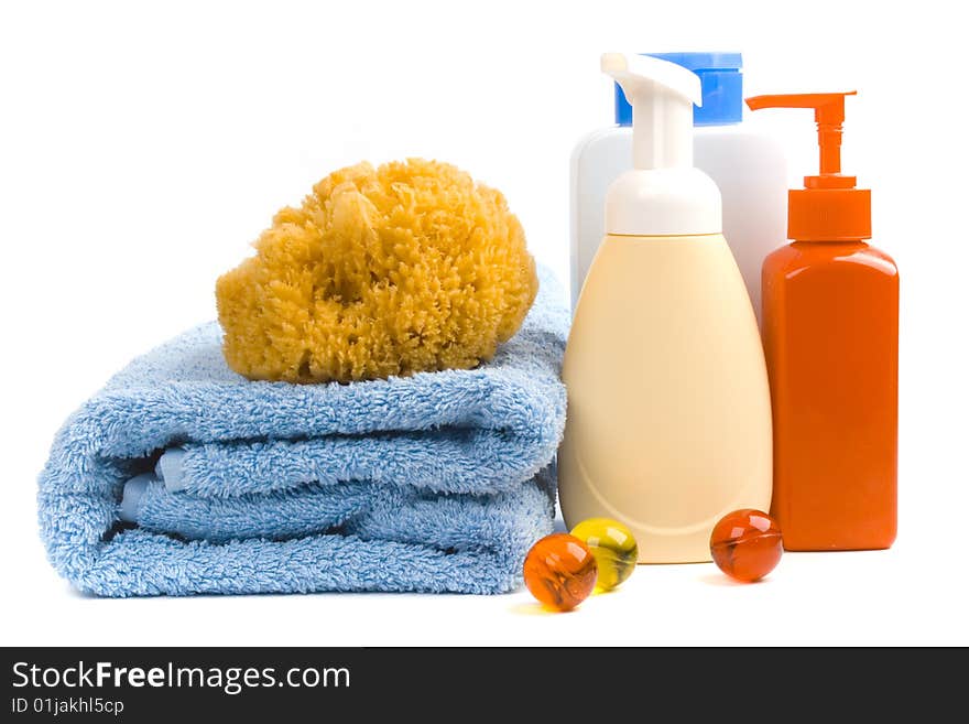 Body care products and towel on white background