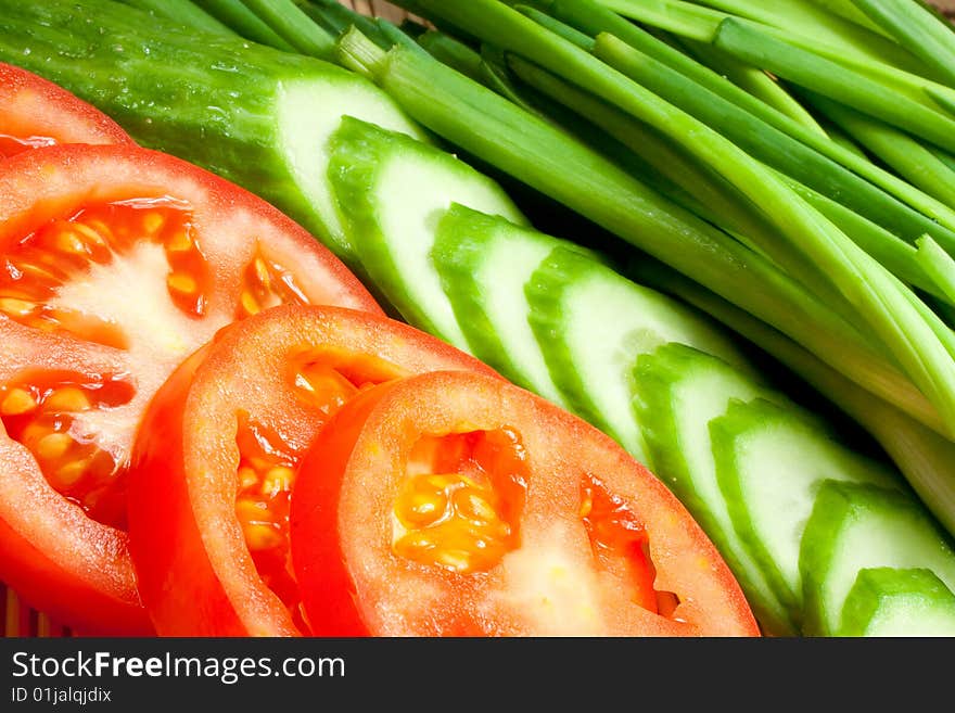 Fresh tomatoes, cucumbers and onions on a kitchen device. Fresh tomatoes, cucumbers and onions on a kitchen device