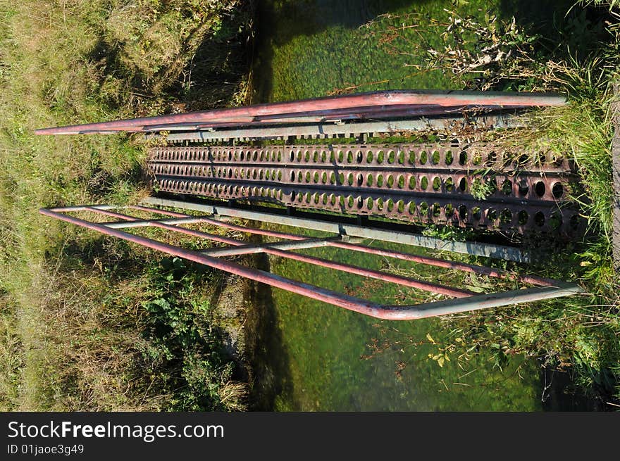 A bridge over an small creek. A bridge over an small creek.