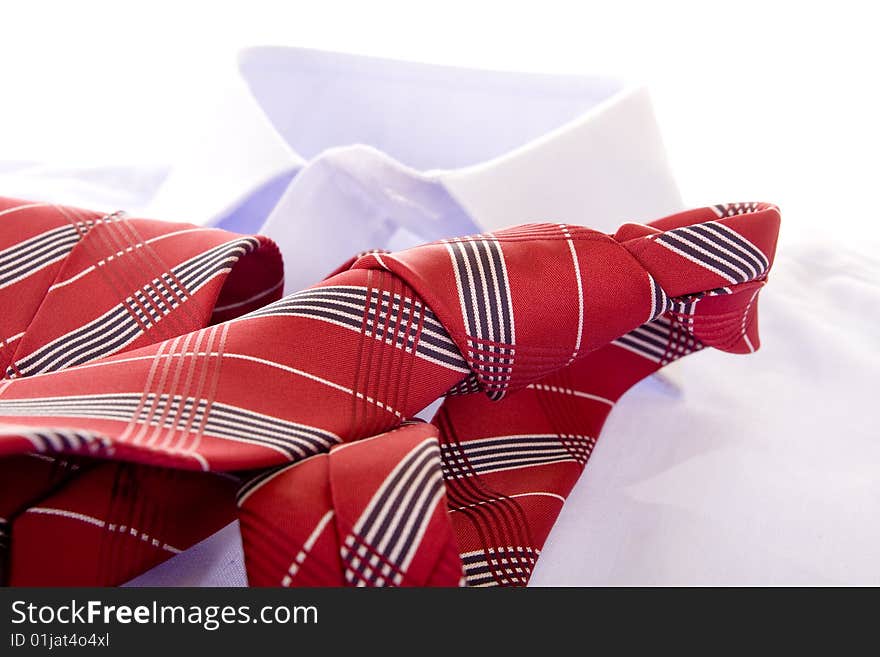 Blue shirt and red tie on white