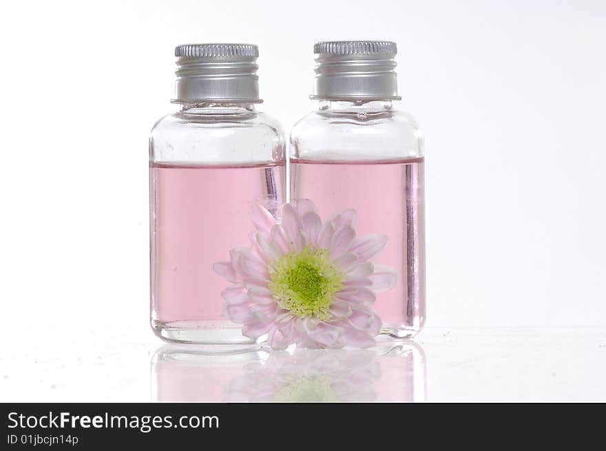 Spa bottles and daisies isolated on white. Spa bottles and daisies isolated on white