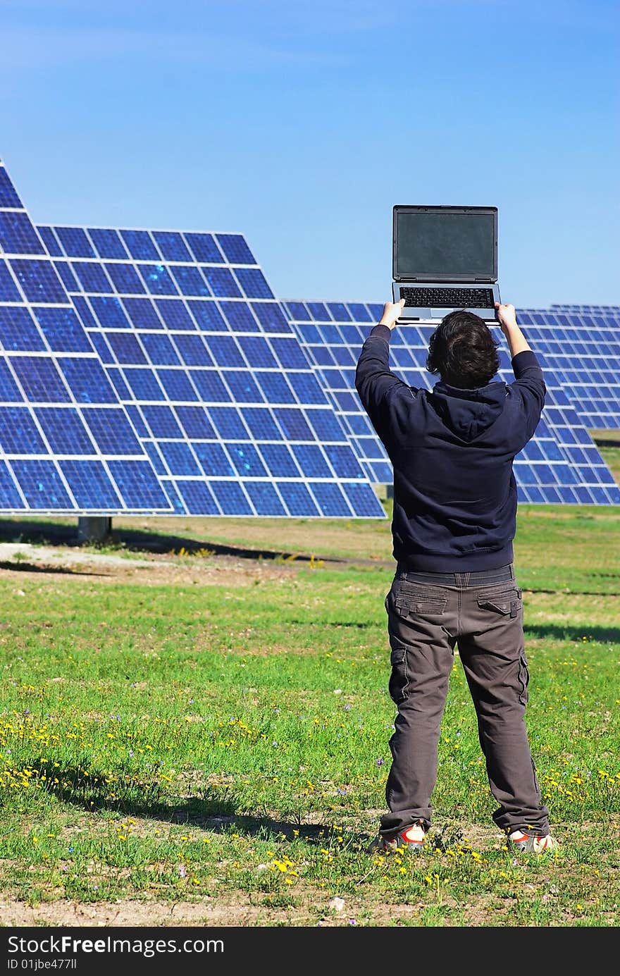 Young man in Central of photovoltaic panels. Young man in Central of photovoltaic panels.