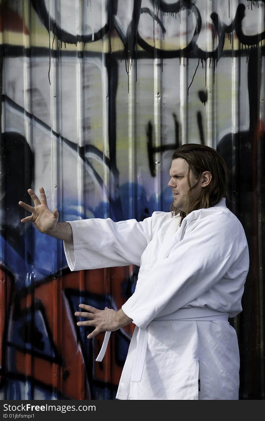 Man practicing martial arts.Has long hair. Man practicing martial arts.Has long hair.