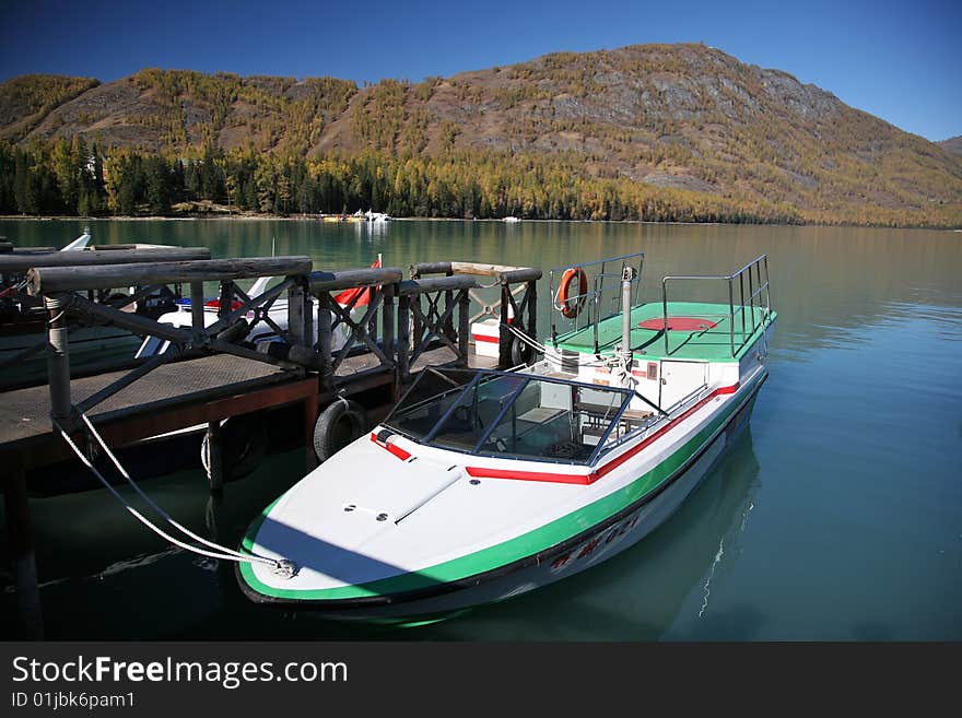 Boat resting at pier at the kanas river in xinjiang,china. Boat resting at pier at the kanas river in xinjiang,china