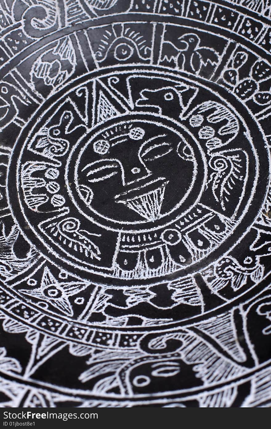 A close up of an Aztec calendar.