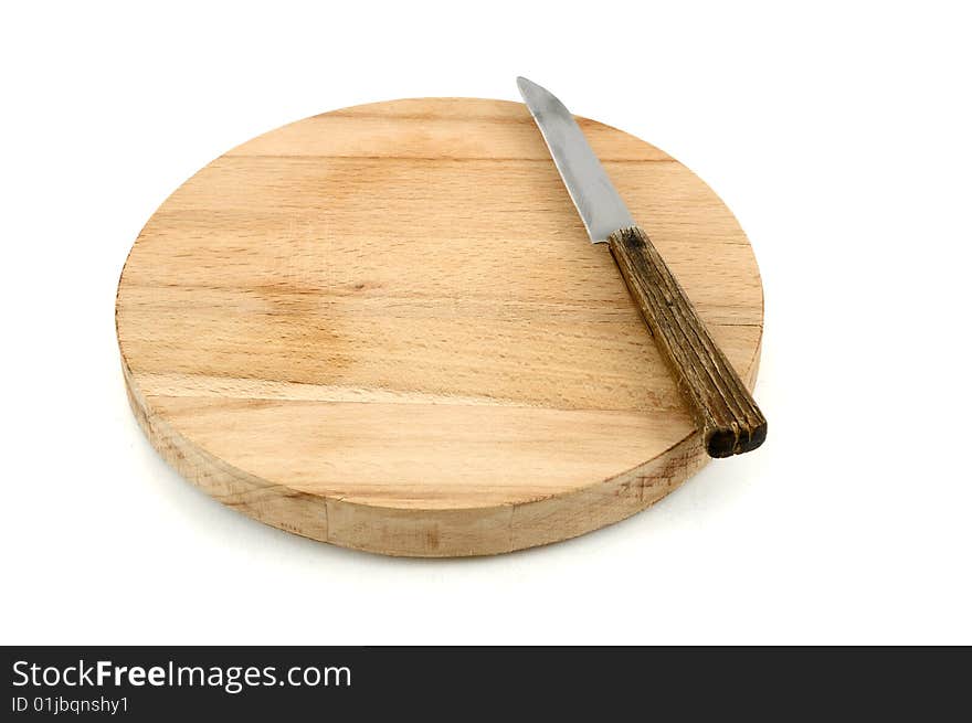 Round chopping board and knife on white background