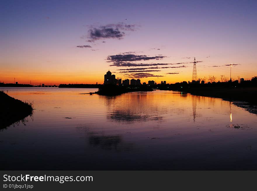 Calm water surface reflection of a sunset. Calm water surface reflection of a sunset