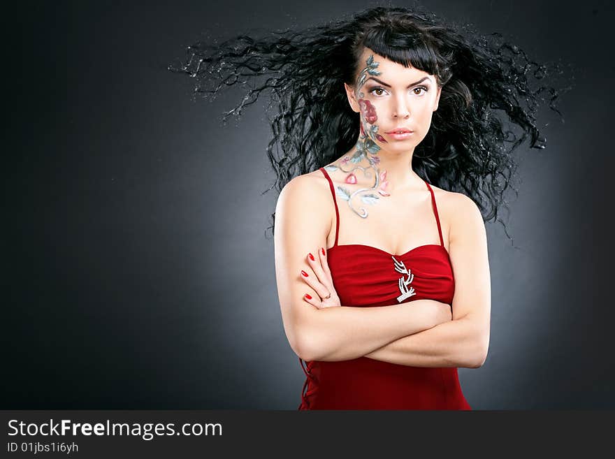 Beauty woman portrait with rose pictures on face on black background