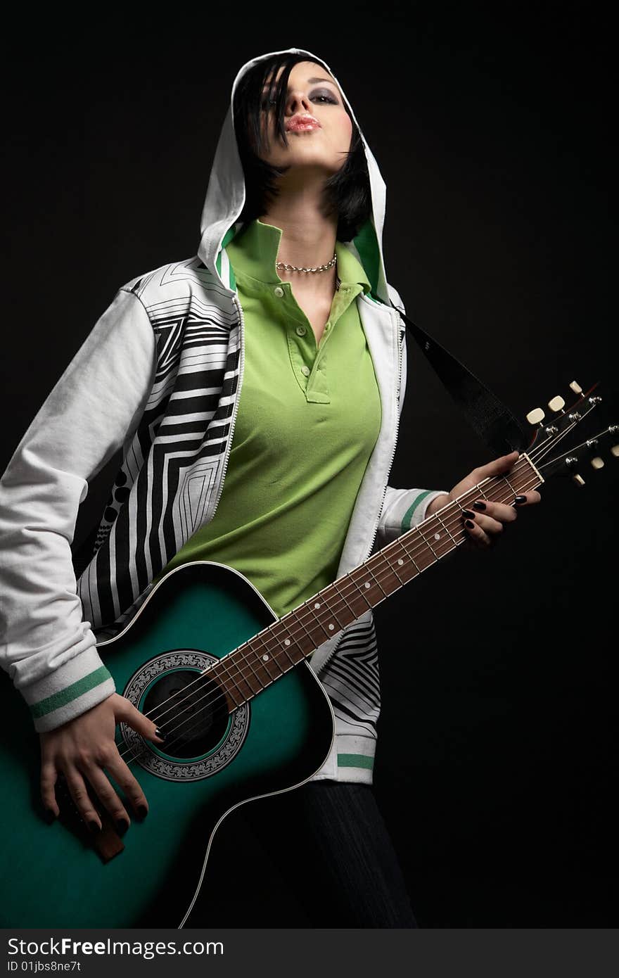 Emo girl with guitar on black background