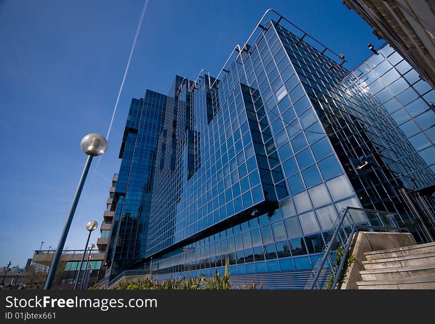 Shiny Glass Office Building Against Blue Sky