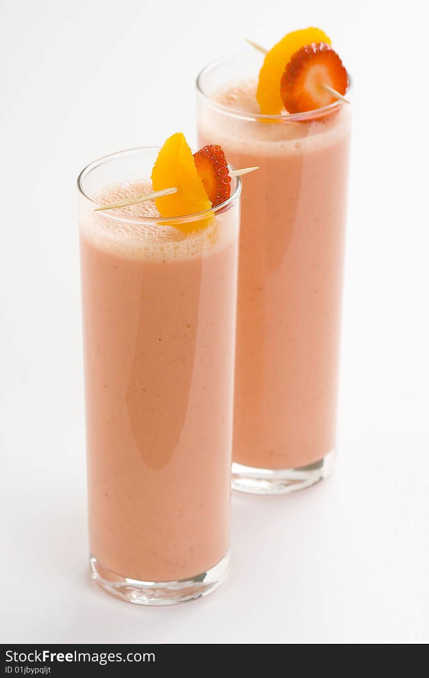 Delicious refreshing strawberry orange banana milkshake natural isolated. Delicious refreshing strawberry orange banana milkshake natural isolated