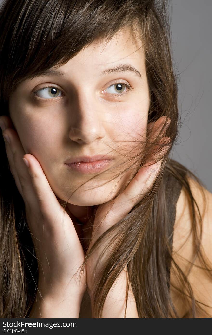 Thoughtful teenager with the dispersed hair portrait