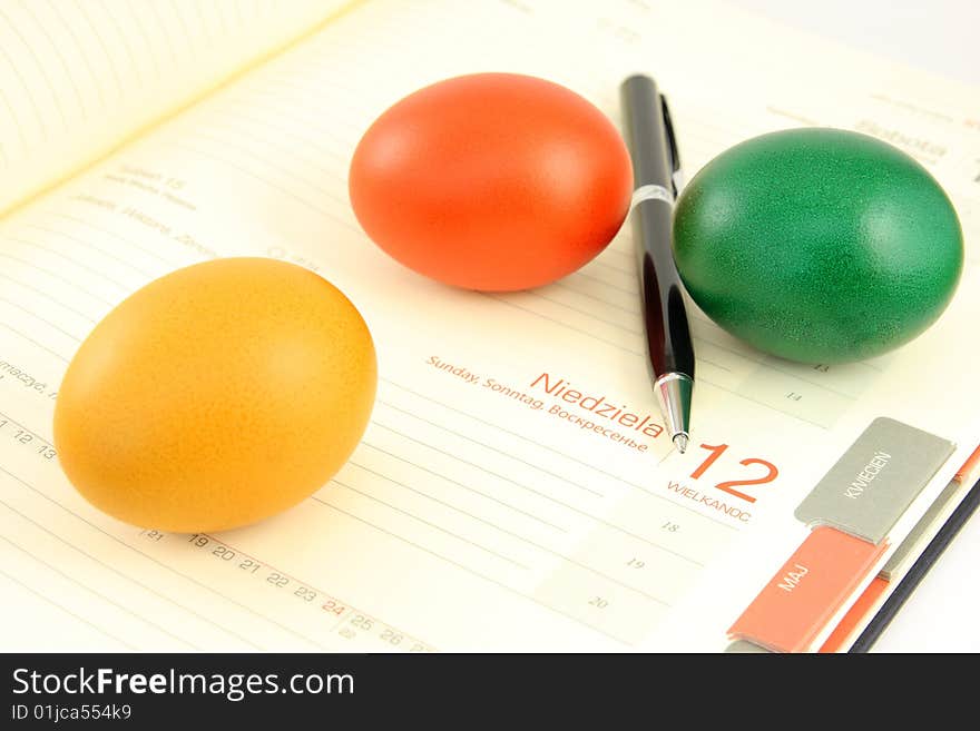 Colored, eggs, and business calendar plus calculator, pen and chart,. Colored, eggs, and business calendar plus calculator, pen and chart,