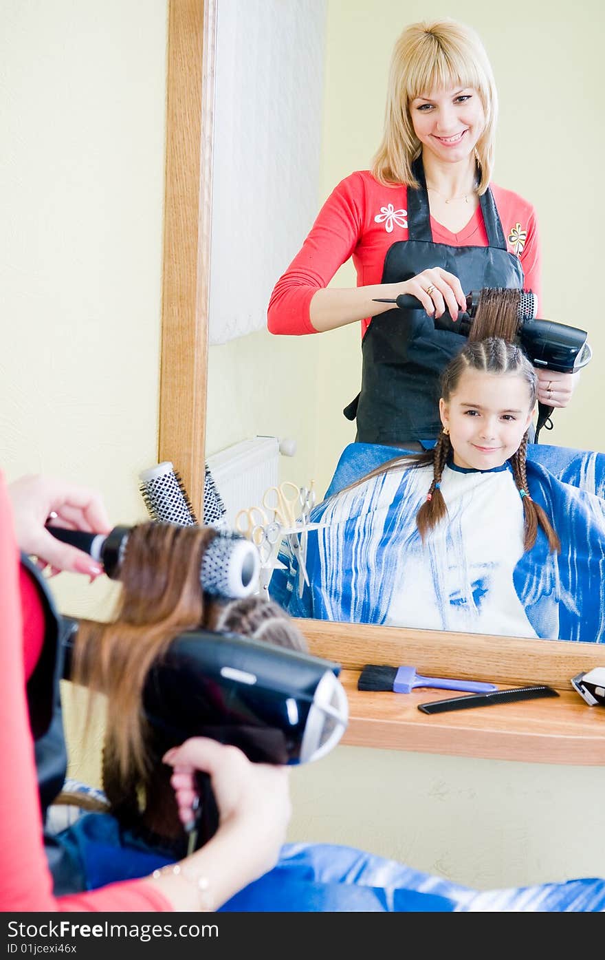 Little girl in hairdresser salon