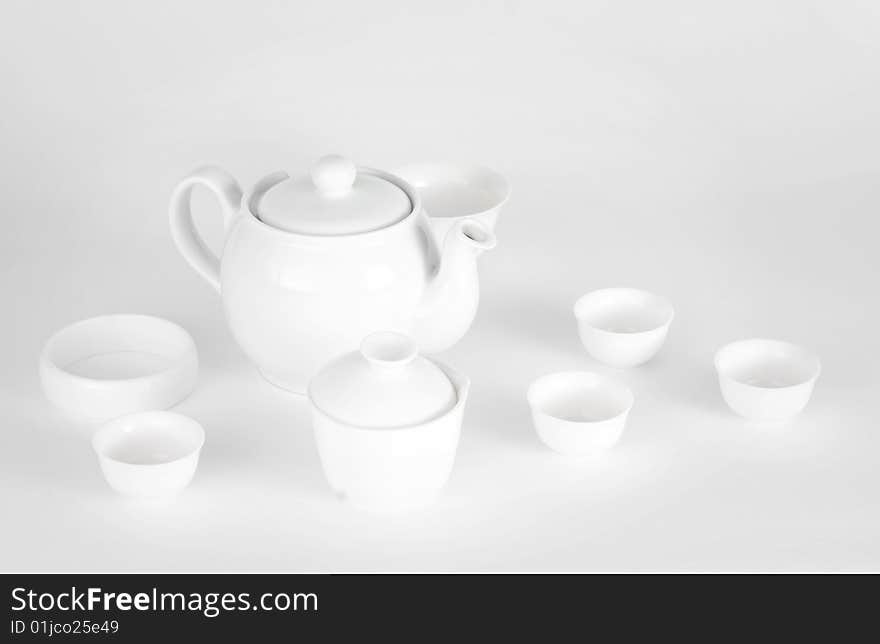 A picture of plain white china teapot and cups. A picture of plain white china teapot and cups