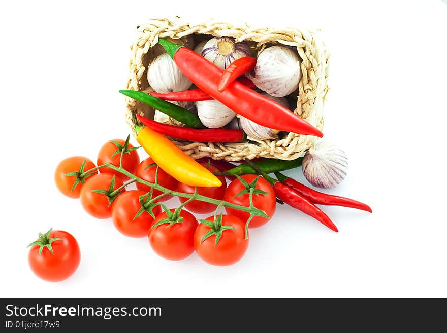 Tomatoes, pepper and garlic in a basket. Tomatoes, pepper and garlic in a basket