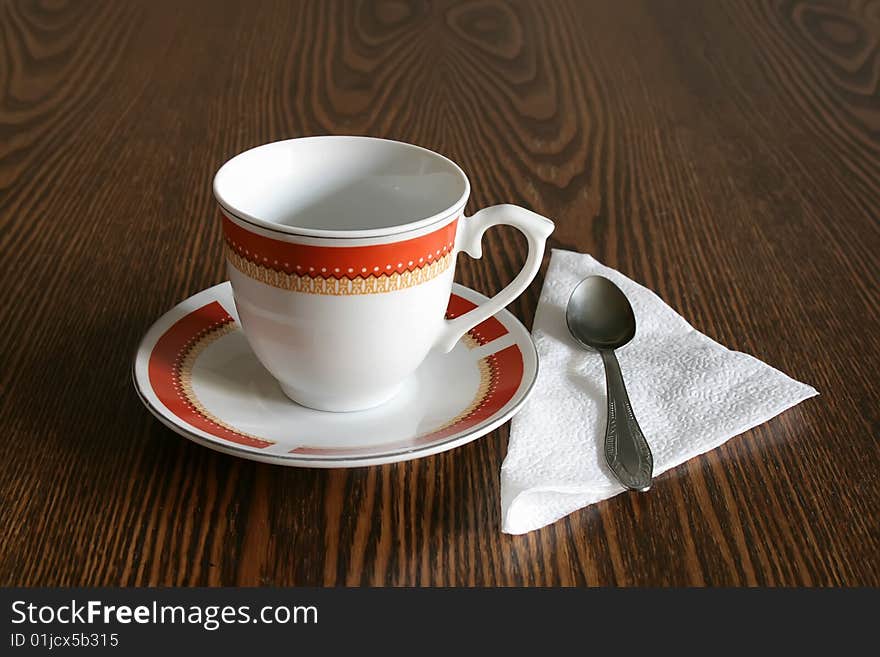 Coffee cup with a saucer on a wooden table