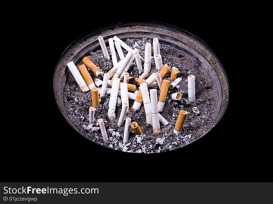 Some cigarettes in ashtray on isolated black background