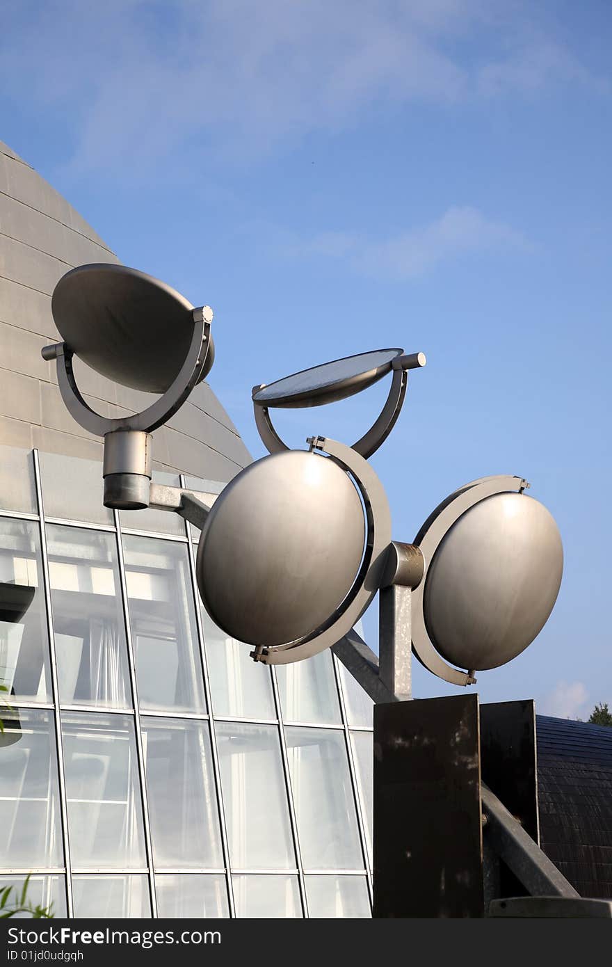 Satellite dishes and building against blue sky. Satellite dishes and building against blue sky.