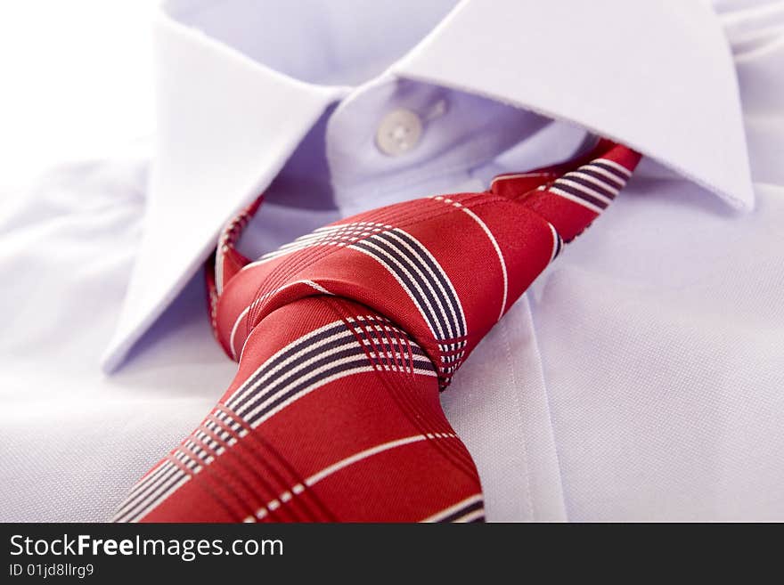 Blue shirt and red tie on white