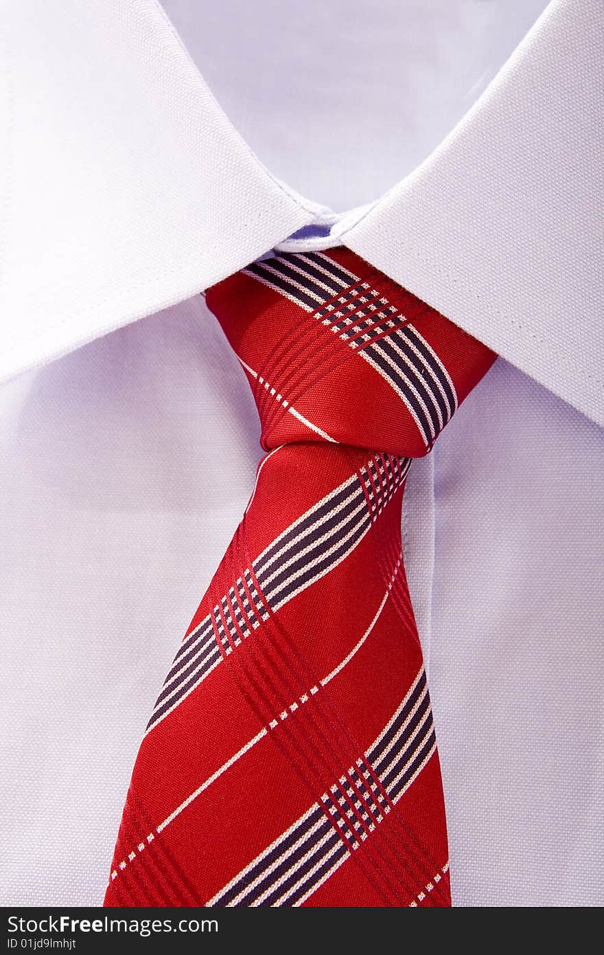 Blue shirt and red tie on white