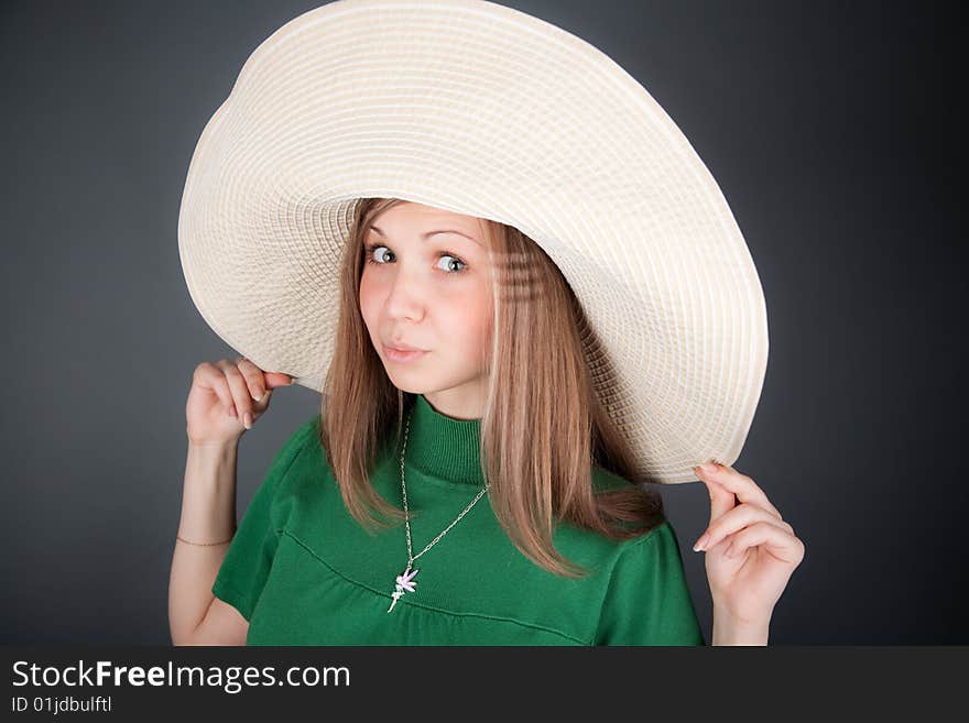 Funny young cutey in a green dress with a big straw hat. Funny young cutey in a green dress with a big straw hat